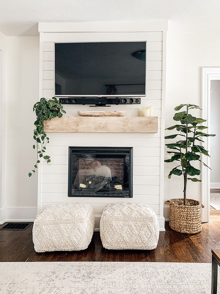 living room with tv over fireplace