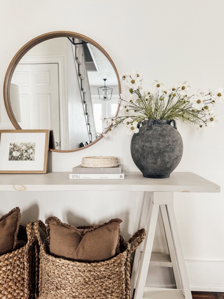 Summer entry table with cosmos in a gray ceramic vase